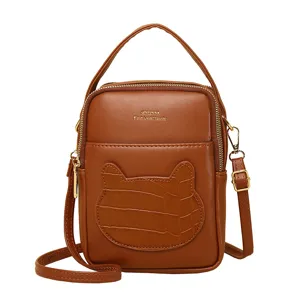 Brown mini crossbody phone bag with cute cat ear design and textured crocodile finish