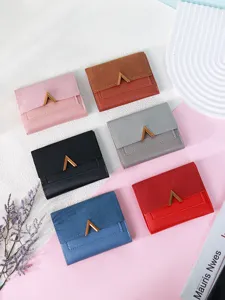 Set of six multi-color tri-fold women's wallets with matte PU leather and V-clasp detail.