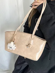 Elegant beige crocodile texture tote bag with stylish knot detail and fluffy keychain