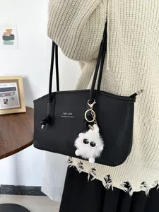 Black PU leather tote bag with large capacity and fluffy white monster keychain detail