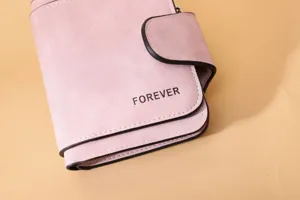 Close-up detail of a pink matte PU leather wallet featuring an embossed FOREVER logo