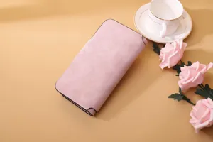 Detail view of a dusty pink frosted PU leather long tri-fold wallet for women