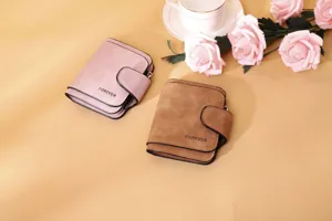 Detail view of pink and brown matte PU leather women's wallets with Forever engraving