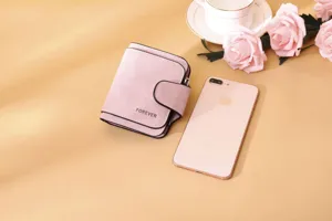 Pink frosted PU leather women's wallet shown with phone for size comparison