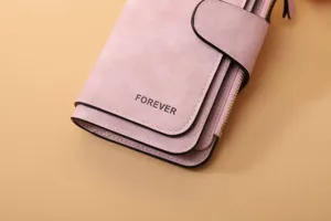 Macro view of pink frosted PU leather long wallet detail with Forever engraving on surface