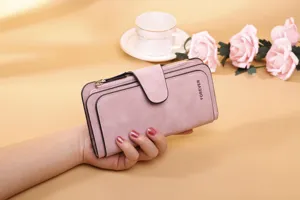 Close-up detail of the pink frosted PU leather women's trifold wallet held by hand.