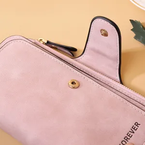 Close-up of pink frosted PU leather women's long wallet with metal snap buckle detail.
