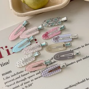 Selection of cute rhinestone and patterned duckbill hair clips for daily styling.