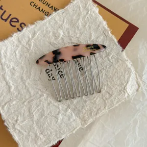 Close-up detail of a vintage tortoiseshell acetate hair comb with durable metal teeth