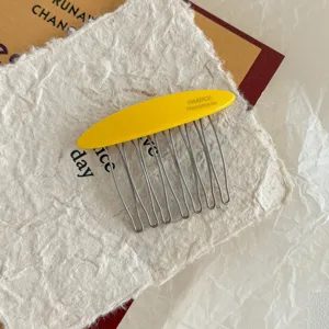Detailed macro view of high-end yellow acetate hair comb with durable metal teeth