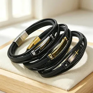 Macro detail of men's multi-layer black braided microfiber bracelet with steel cross plate.