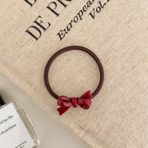 Close-up of the red bow detail on a durable high elasticity hair tie for women