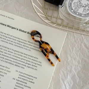 Close-up of small tortoise shell acetate U-shaped hair fork for bun styling