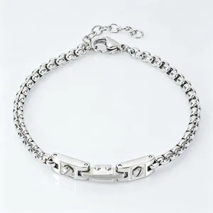 High-detail view of a stainless steel bracelet featuring watchband style links and box chain