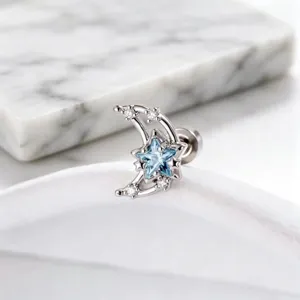 Detailed macro view of a silver crescent moon earring with a light blue star zircon