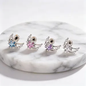Close-up of four crescent moon and star stud earrings with colorful zircons