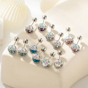 Detailed view of ocean-themed seashell and starfish cartilage stud earrings in silver
