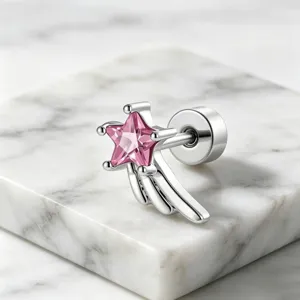 Close-up detail of a silver shooting star stud earring featuring a vibrant pink zircon