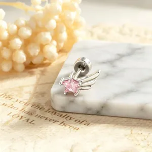 Close-up of minimalist silver star stud earring with pink zircon and angel wing detail
