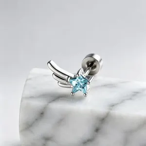 Detailed close-up of the star-shaped blue zircon earring with silver wing design element