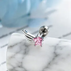Close-up macro view of a pink star zircon wing stud earring on a marble pedestal