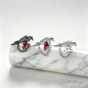 Detailed macro view of bird-shaped earrings with rhombic zircons and delicate chains