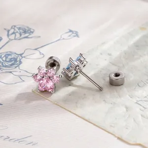 Macro detail of cute pink zircon cat paw stud earrings showing secure screw-back design