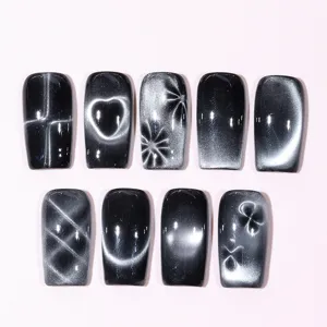 Macro detail of various cat-eye nail magnetic patterns including hearts and stars