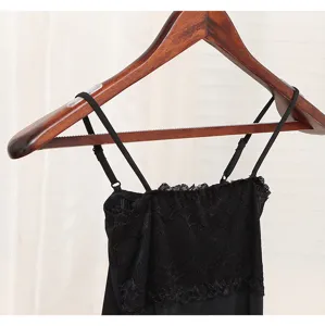 Transparent anti-slip silicone strips on a wooden hanger with black lace garment detail