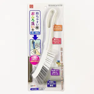 Multi-purpose gap cleaning brush for bathroom tiles and taps in its retail packaging