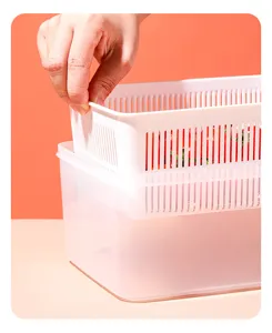 Close-up of lifting the inner white drain basket from the clear plastic storage box