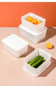 Detail showing stackable double-layer drainage baskets containing fresh fruit and vegetables