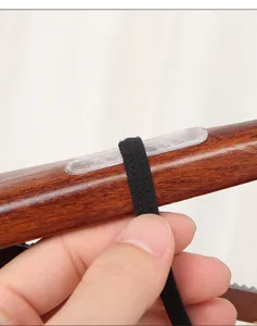 Close-up of transparent non-slip strip on a wooden hanger for backpack straps