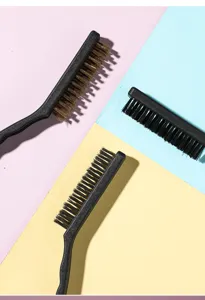 Detailed view of three kitchen cleaning brushes with copper and nylon bristles