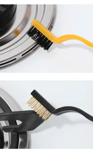Detailed view of ergonomic curved cleaning brushes scrubbing a gas stove burner effectively