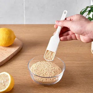 White plastic adjustable measuring spoon for accurate kitchen baking and spice portioning