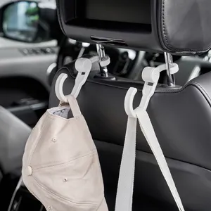 Versatile white car headrest hooks for seat back storage holding a cap and bag strap