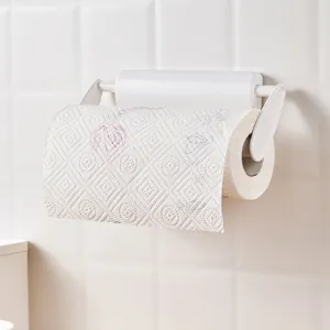 White wall-mounted kitchen paper towel holder on a tiled wall