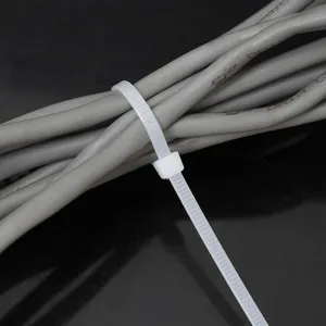 Durable white self-locking nylon cable tie securing a bundle of grey electrical wires