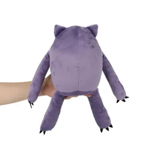 Macro view showing the back and stitching detail of the purple Mochi monster plush toy.