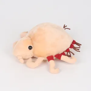 Vue détaillée d'une peluche de morpion beige avec des détails de pattes rouges et doux