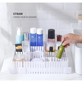 White adjustable plastic drawer dividers organizing skincare products on bathroom counter.