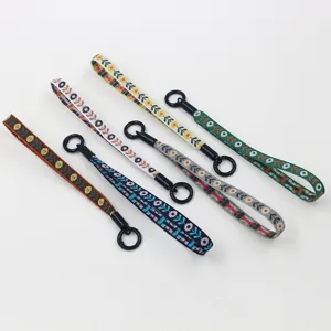 Detailed macro view of five colorful ethnic style woven wrist lanyards with black rings.