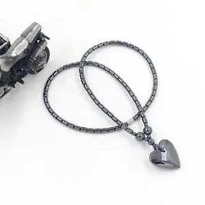 Elegant dark grey metallic bead necklace featuring a smooth heart-shaped pendant detail