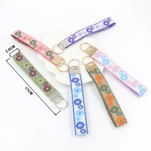 Macro view showing 17cm length and 2cm width of floral embroidered wristlet keychains
