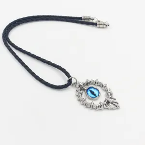 Close-up of a blue dragon eye pendant with a silver flame frame on a braided cord