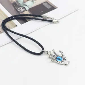 Detail view of vintage alloy dragon eye pendant necklace with black braided leather rope