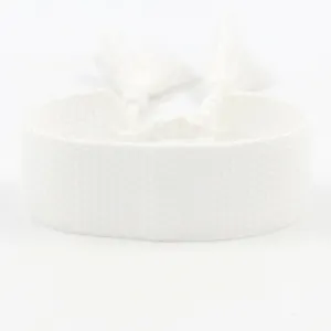 Detailed view of white woven fabric DIY bracelet featuring tassels for embroidery