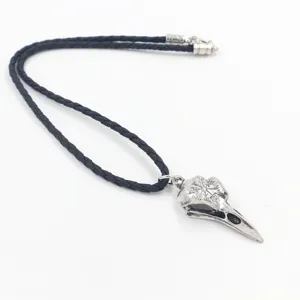 Antique silver Viking crow skull pendant with Nordic symbols on black braided leather cord