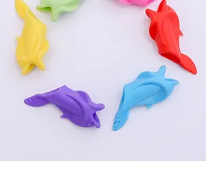 Silicone dolphin pen grip corrector for kids writing practice, colorful detail view.